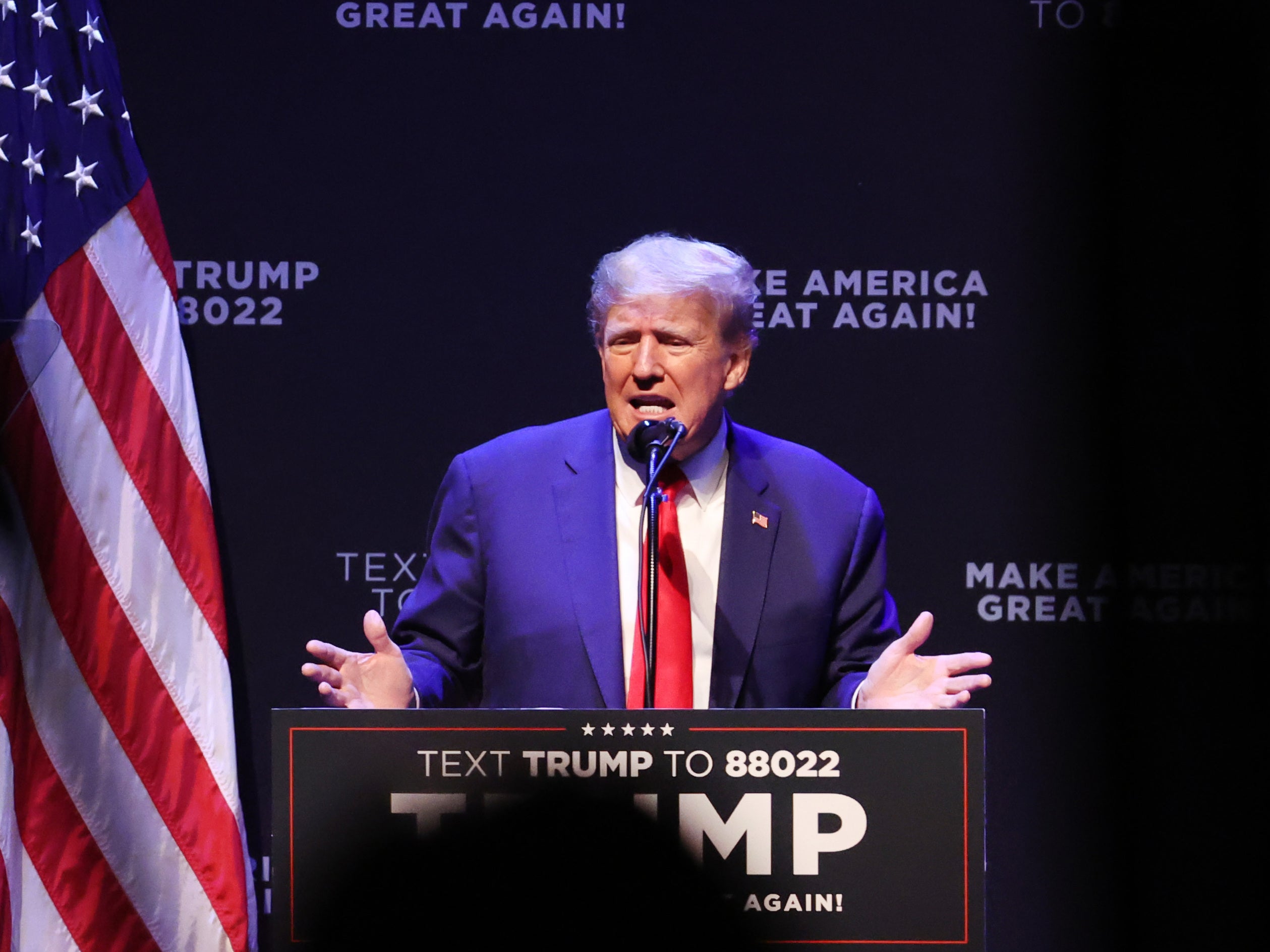 Former President Donald Trump, pictured here speaking to guests at Iowa's Adler Theatre