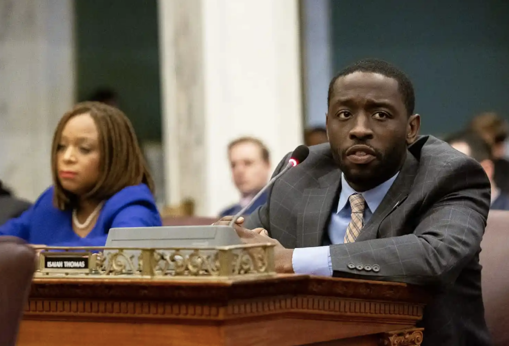 Councilmember Isaiah Thomas sitting at his desk in City Council chambers