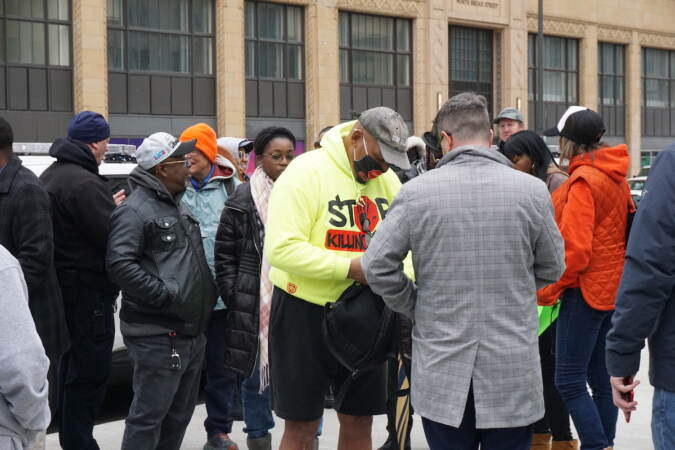 Jamal Johnson speaks with a crowd.