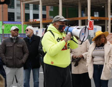 Jamal Johnson speaks into a megaphone.