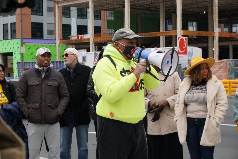 Jamal Johnson speaks into a megaphone.