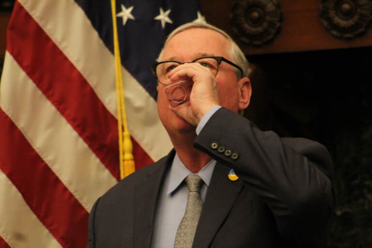 Mayor Kenney takes a sip of water.