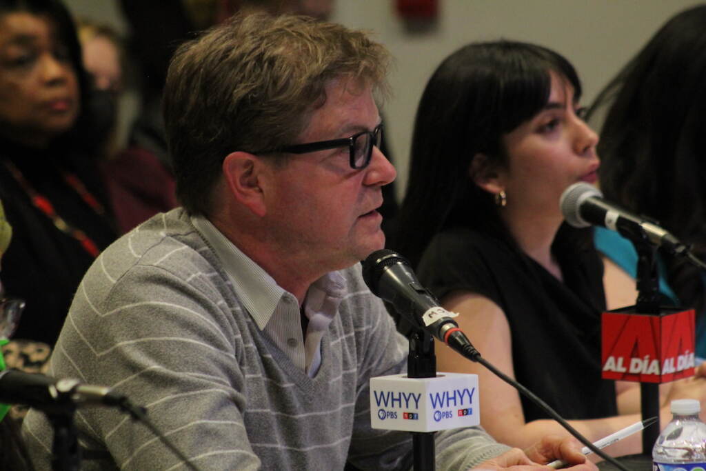 WHYY News' reporter Peter Crimmins speaks into a microphone.