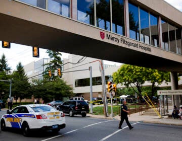 A walkway has a sign that reads Mercy Fitzgerald Hospital.