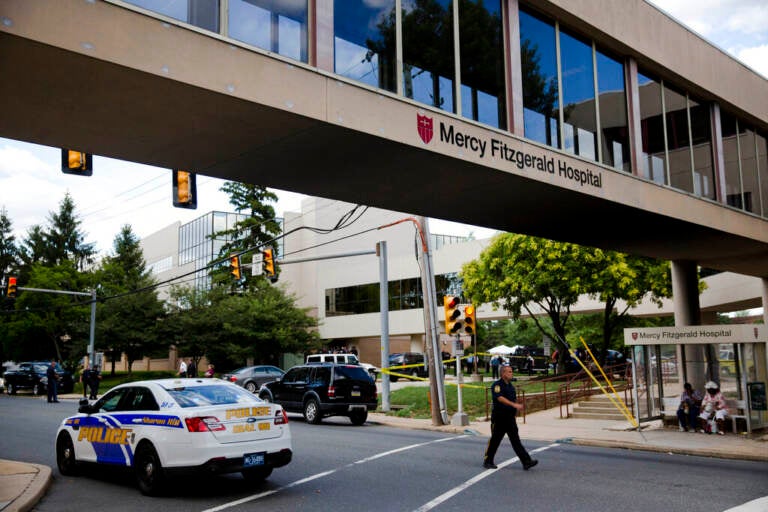 A walkway has a sign that reads Mercy Fitzgerald Hospital.