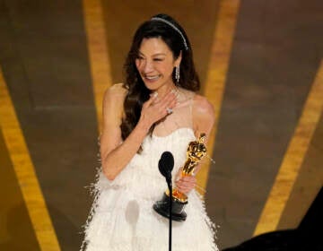 Michelle Yeoh accepts the award for best performance by an actress in a leading role for 