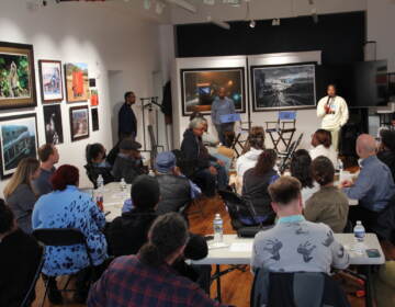 Dozens gathered to discuss the hot button issue at the Ubuntu Fine Art Gallery. (Cory Sharber/WHYY)