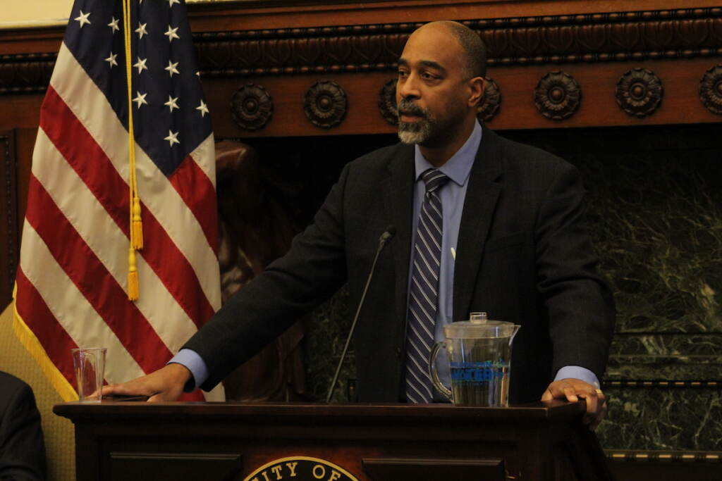 OTIS Deputy Managing Director Mike Carroll speaks at a podium.