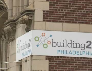 A close up of a brick building with a sign that reads building 21.