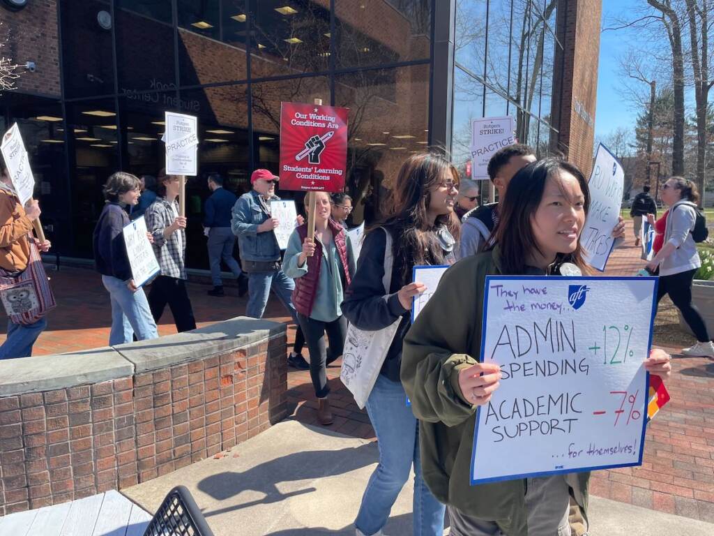 Protesters march with signs.