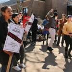 Faculty and staff hold picket signs on the Camden campus of Rutgers University.