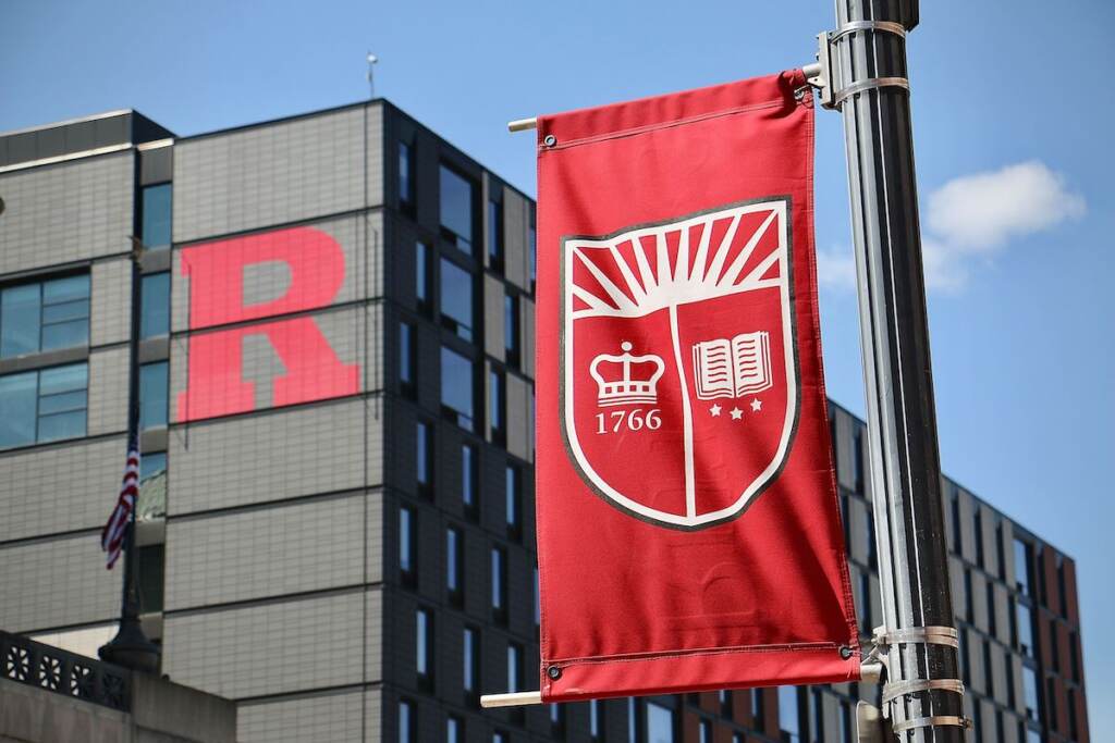 A red banner and a building with a red "R" emblazoned on its side are visible.