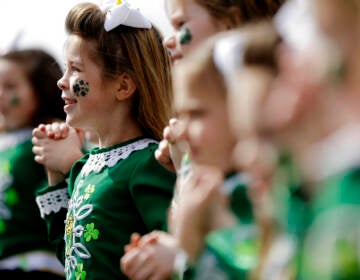 A close-up of children performing, wearing all green for St. Patrick's Day.