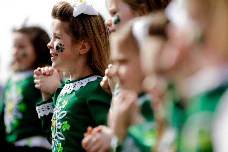 A close-up of children performing, wearing all green for St. Patrick's Day.