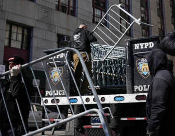 Barricades are unloaded from a truck near the courts in New York