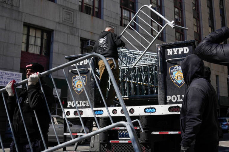 Barricades are unloaded from a truck near the courts in New York