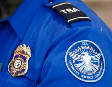 FILE - A Transportation Security Administration officer works at Dallas Love Field Airport on June 24, 2020, in Dallas. A man was arrested Monday, Feb. 27, 2023, after an explosive was found in a bag checked onto a Florida-bound flight at Lehigh Valley International Airport federal authorities said. (AP Photo/Tony Gutierrez, File)