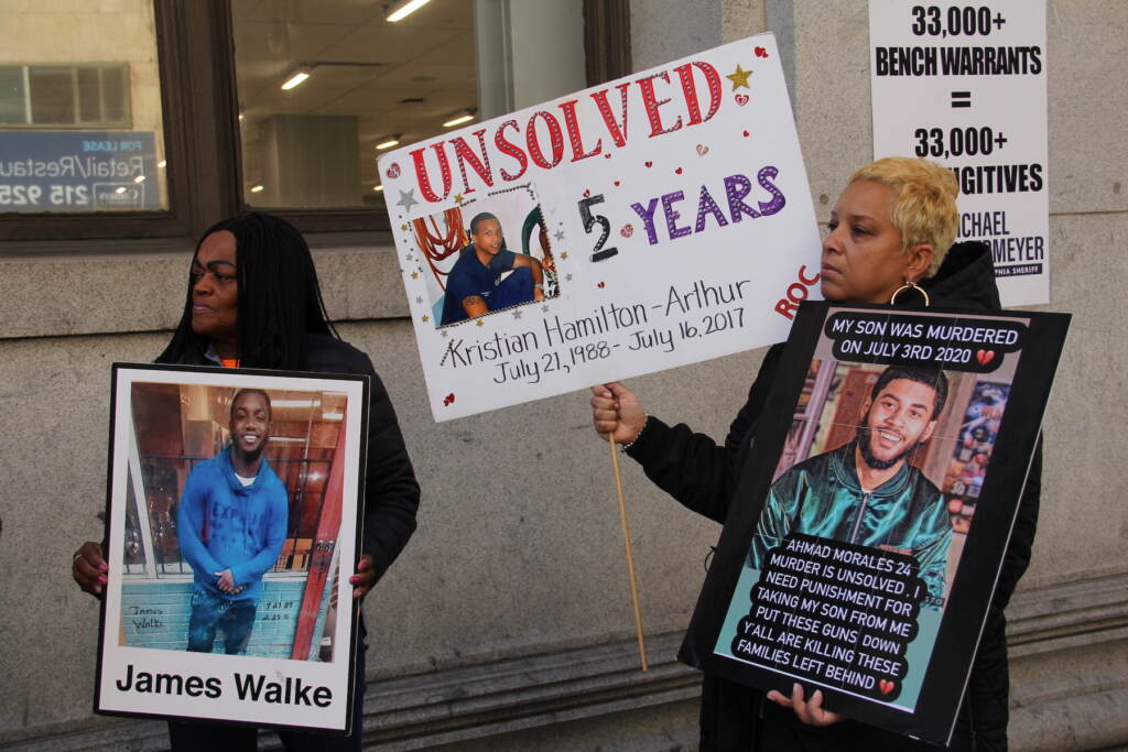 Victims of gun violence in Philadelphia hold signs supporting Untermeyer's campaign for Philadelphia sheriff.