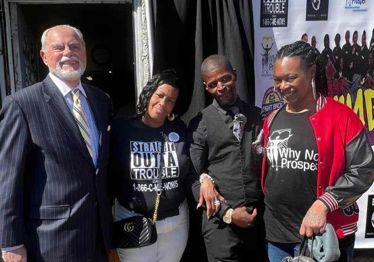 Byron Cotter, Michelle Anne Simmons, Marcus Pearson and Delia Avery pose for a photo outdoors.