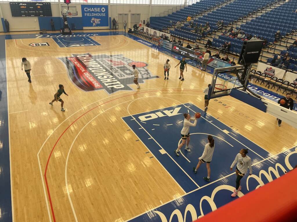 An aerial view of basketball players practicing before a game.