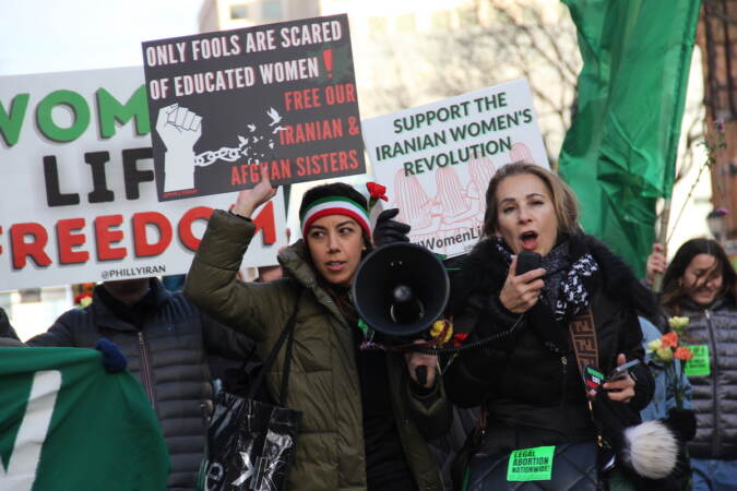 People hold signs and megaphones.