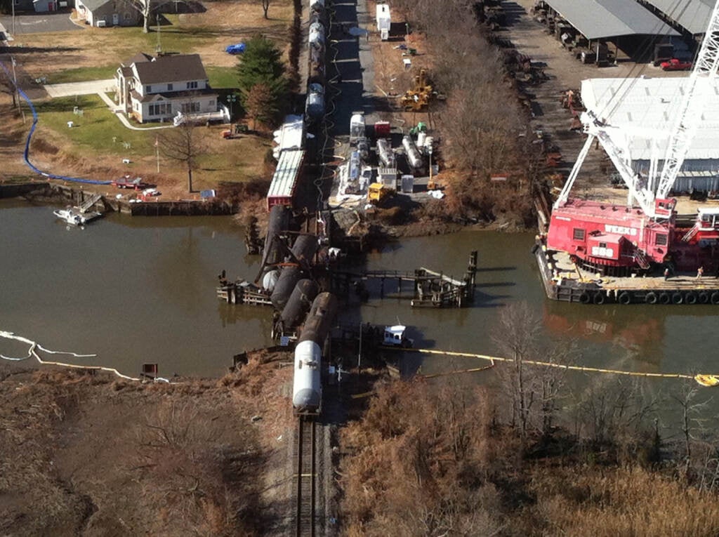 A crane was used to remove rail cars from the water by Gary Stevenson’s home after a train derailed in Paulsboro, N.J.