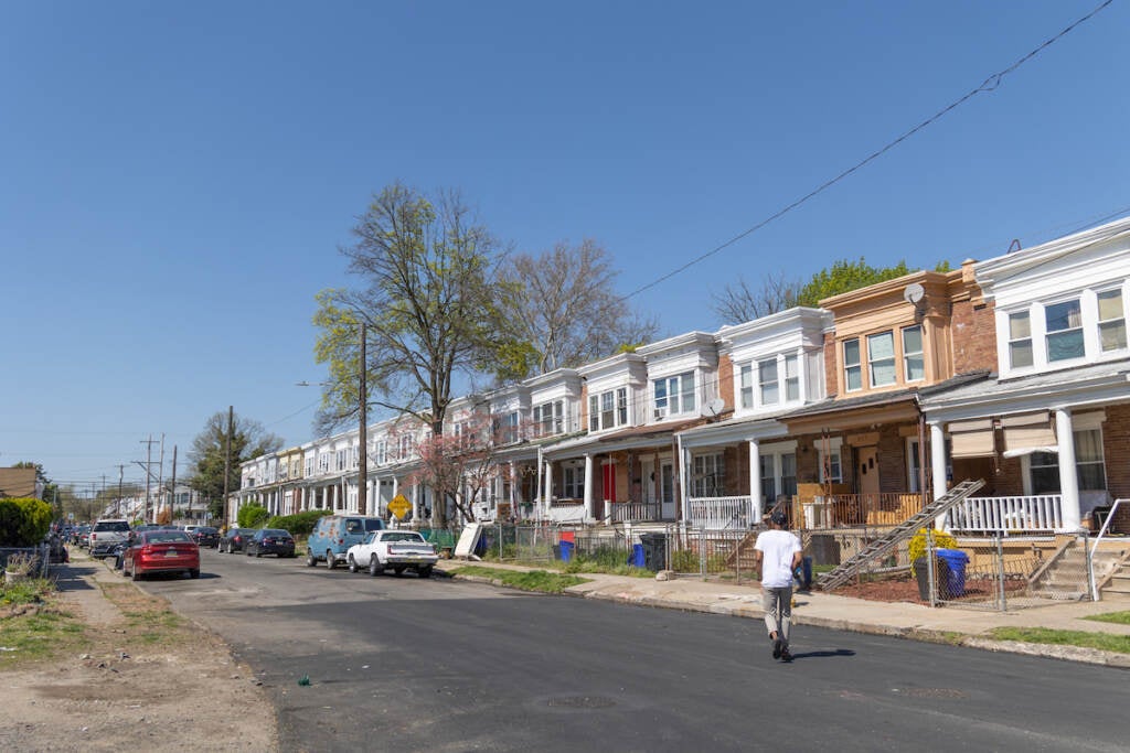 Rowhomes on a street on a sunny day.