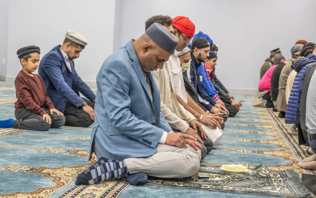 Ahsan Mohar (center) offers prayers after breaking the fast during an Interfaith Iftar at Baitul Aafiyat Mosque on Saturday evening