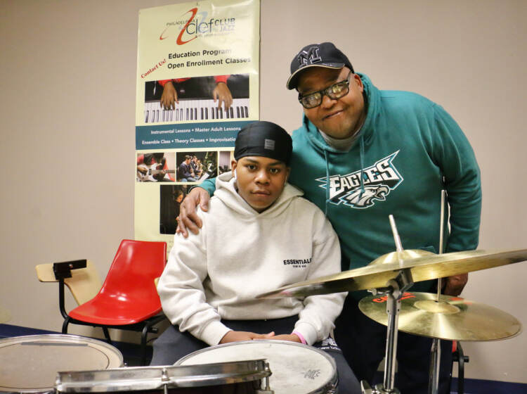 Michael Barnes embraces his 13-year-old son, Elijah, behind a drum set at the Clef Club.