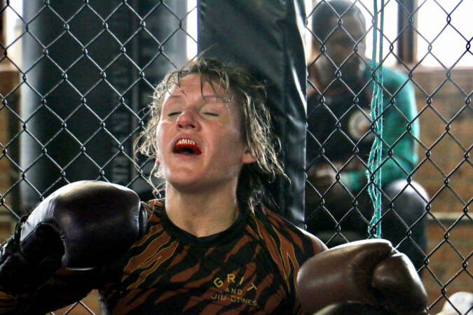 DeAnna Bennett rests between bouts during practice at Marquez MMA Gym, where she faced a series of fresh opponentsin rapid succession.