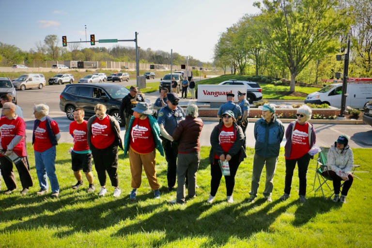 Tredyffrin Township police arrest protesters at the Matthews Road entrance to Vanguard offices. (Emma Lee/WHYY)