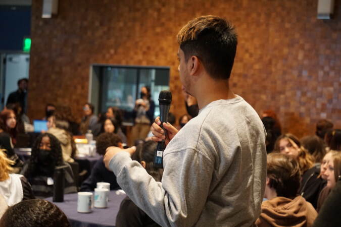 A student asks a question to a panel of climate experts. (Sam Searles/WHYY)