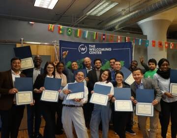 Participants in The Welcoming Center's International Professionals Program pose during a ceremony celebrating the program