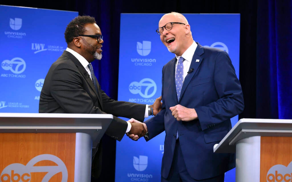 Chicago mayoral candidates Brandon Johnson (left) and Paul Vallas shake hands before the start of a debate at ABC7 studios in downtown Chicago