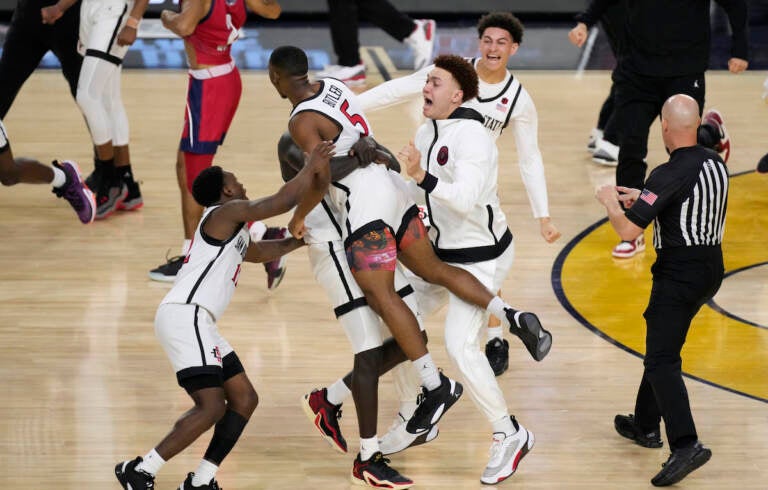 San Diego State guard Lamont Butler (5) celebrates with teammates after hitting the winning basket against Florida Atlantic during the second half of a Final Four college basketball game in the NCAA Tournament on Saturday, April 1, 2023, in Houston