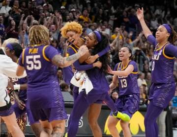 LSU players celebrate a last second shot during the first half of the NCAA Women's Final Four championship basketball game against Iowa Sunday, April 2, 2023, in Dallas. (AP Photo/Darron Cummings)