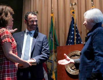 Treasury Secretary Janet Yellen congratulates new IRS commissioner Danny Werfel after the swearing-in at the IRS headquarters in Washington