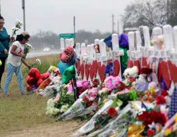 Christina Osborn and her children Alexander Osborn and Bella Araiza visit a makeshift memorial for the victims of the shooting at Sutherland Springs Baptist Church