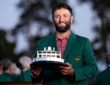 Jon Rahm, of Spain, holds up the trophy after winning the Masters golf tournament at Augusta National Golf Club on Sunday, April 9, 2023, in Augusta