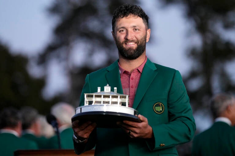 Jon Rahm, of Spain, holds up the trophy after winning the Masters golf tournament at Augusta National Golf Club on Sunday, April 9, 2023, in Augusta