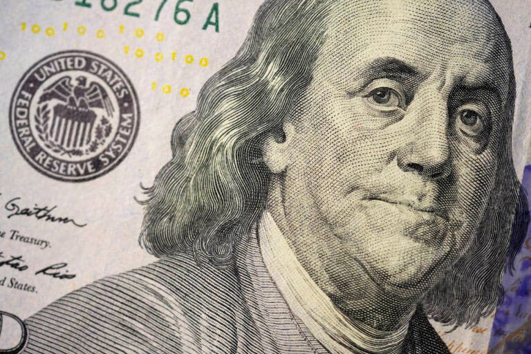 The likeness of Benjamin Franklin is seen on a U.S. $100 bill, Wednesday, Feb. 22, 2023, in Marple Township