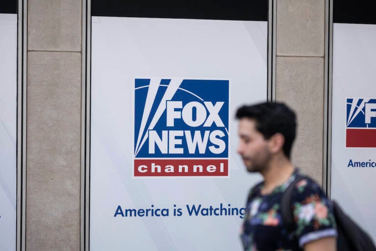 A person walks past the Fox News Headquarters in New York