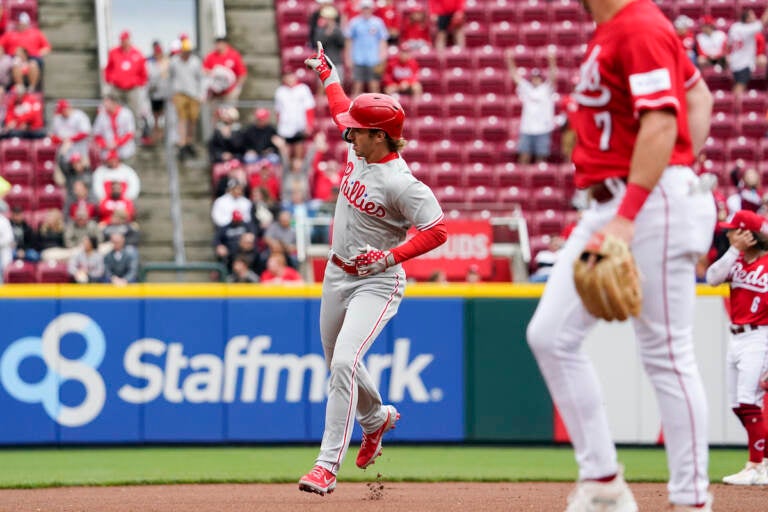 Philadelphia Phillies' Bryson Stott (center) points to the crowd after hitting a solo home run during the first inning of a baseball game against the Cincinnati Reds, Sunday, April 16, 2023, in Cincinnati