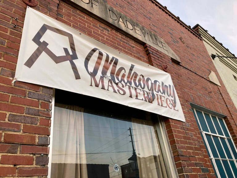 A bullet hole is visible in the glass transom over the door at the Mahogany Masterpiece dance studio in Dadeville