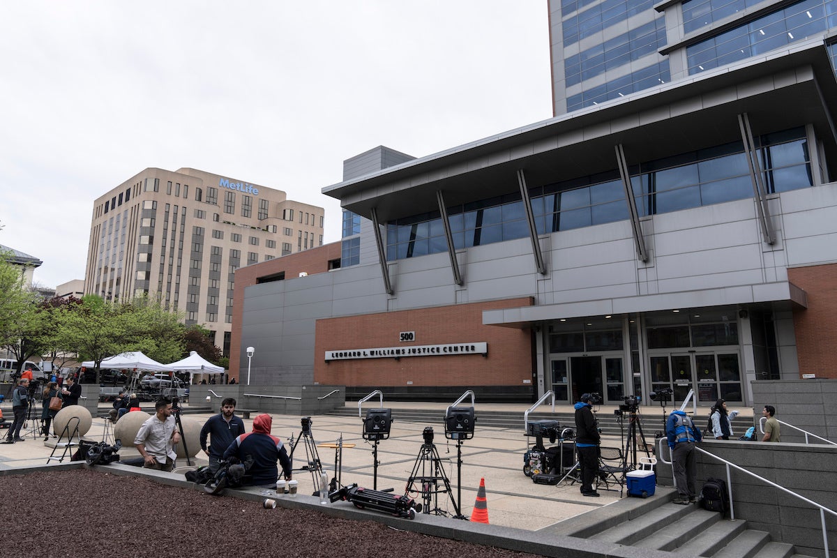 Members of the media gather outside the justice center in Wilmington, Del.