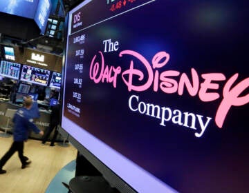 The Walt Disney Co. logo appears on a screen above the floor of the New York Stock Exchange