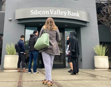People stand outside a Silicon Valley Bank branch in Santa Clara, Calif., Friday, March 10, 2023. The Federal Reserve is scheduled Friday to release a highly-anticipated review of its supervision of Silicon Valley Bank, the go-to bank for venture capital firms and technology start-ups that failed spectacularly in March. 
(AP Photo/Jeff Chiu, File)