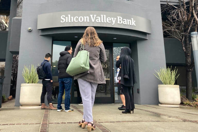 People stand outside a Silicon Valley Bank branch in Santa Clara, Calif., Friday, March 10, 2023. The Federal Reserve is scheduled Friday to release a highly-anticipated review of its supervision of Silicon Valley Bank, the go-to bank for venture capital firms and technology start-ups that failed spectacularly in March. 
(AP Photo/Jeff Chiu, File)