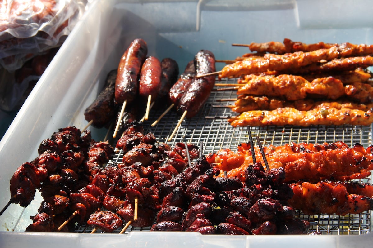 Various grilled meats on a tray at the Southeast Asian Market