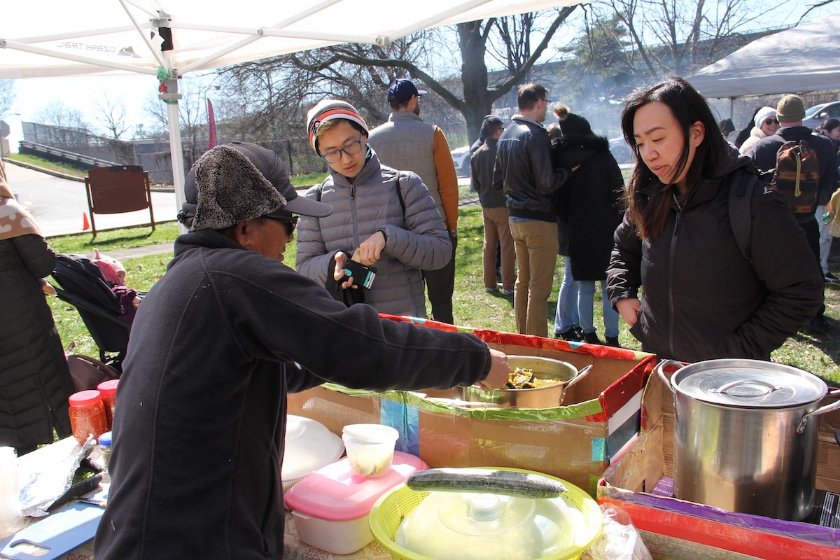 Roeun Chum serves soup to some patrons